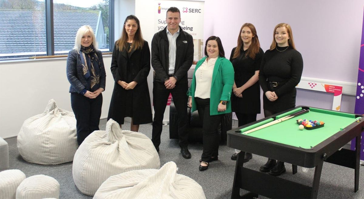 A line up of 6 people in the Downpatrick wellbeing room, featuring a pool table and bean bags